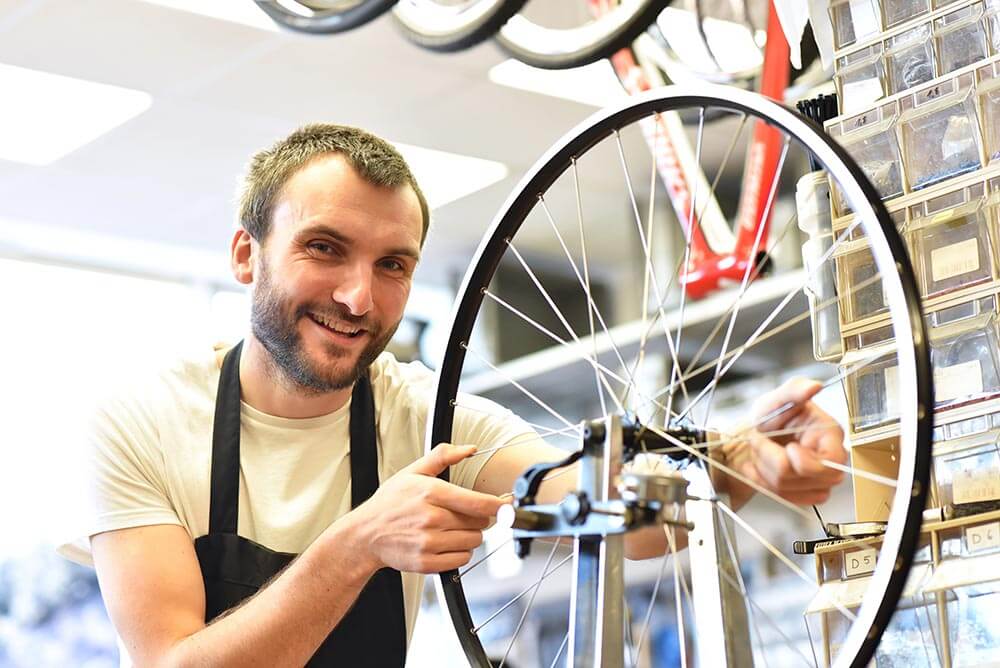 bicycle mechanic in a workshop repairs a bike